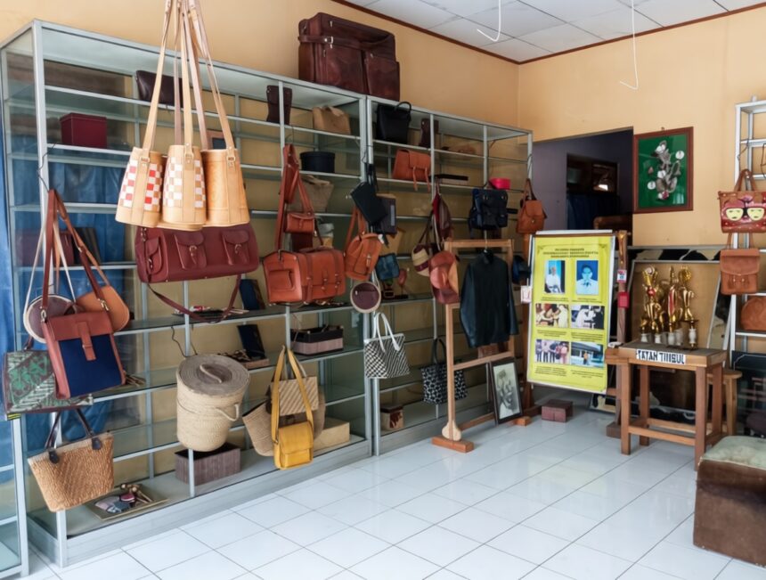 kerajinan manding by bantulkab go id FIXX - Mabur.co Boutique display of leather handbags and purses on metal shelves in a sunny shop interior