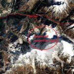 Satellite image of a mountainous area with red boundary lines; a red circle highlights a snow-covered slope labeled 'Suspected avalanche region'.