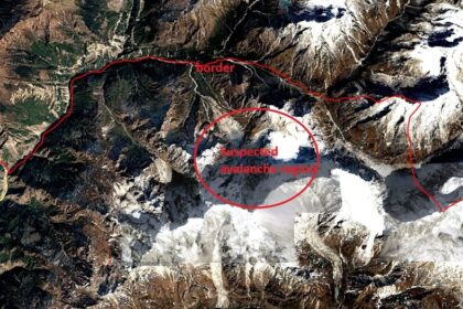 Satellite image of a mountainous area with red boundary lines; a red circle highlights a snow-covered slope labeled 'Suspected avalanche region'.