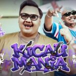 Two men in sunglasses pose on a vibrant music video cover with a bold purple title across the center and graffiti text elements around them.