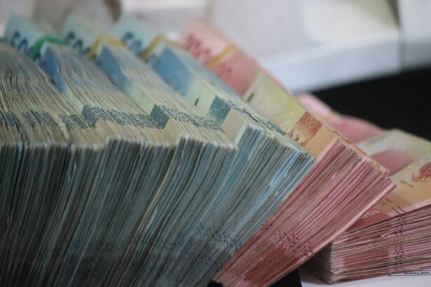 A close-up of colorful stacked banknotes fanned out in rows, showing multiple denominations and colors (e.g., euros).