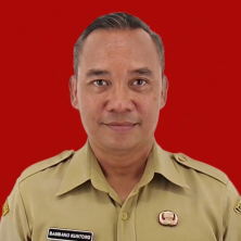 Head-and-shoulders portrait of a man in a beige official uniform with badges, posed against a red background.
