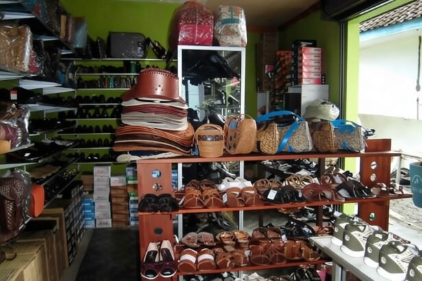 Indoor shop with shelves of leather handbags, sandals, and sneakers arranged on wooden racks.