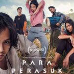 Close-up of a young man in the foreground with a group of dancers in a field, a drum player and a woman seated nearby; Sundance logo and the film title PARA PERASUK appear at the bottom—poster vibe of a contemporary indie film climb.