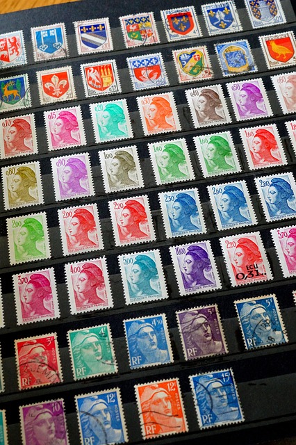A sheet of assorted postage stamps arranged in diagonal rows, showing portraits, coats of arms, and crests in many colors on a dark background.