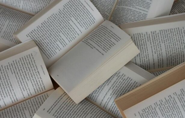 Several paperback books opened to pages, scattered in a pile and full of text.