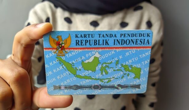 Indonesian ID card (KTP) with Garuda emblem and a map of Indonesia being held by a person.