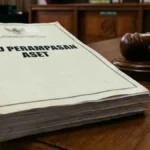 A large legal document titled 'RUU PERAMPASAN ASET' on a wooden table next to a judge's gavel in a courtroom setting.