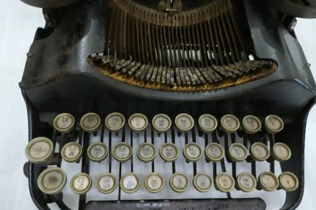 Front view of a vintage manual typewriter with cream circular keys and visible typebars, showing the keyboard and rusted metal frame.