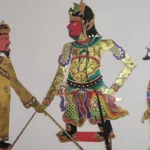 Three ornate warrior figures in colorful traditional robes, standing with swords, mid-heroic scene.