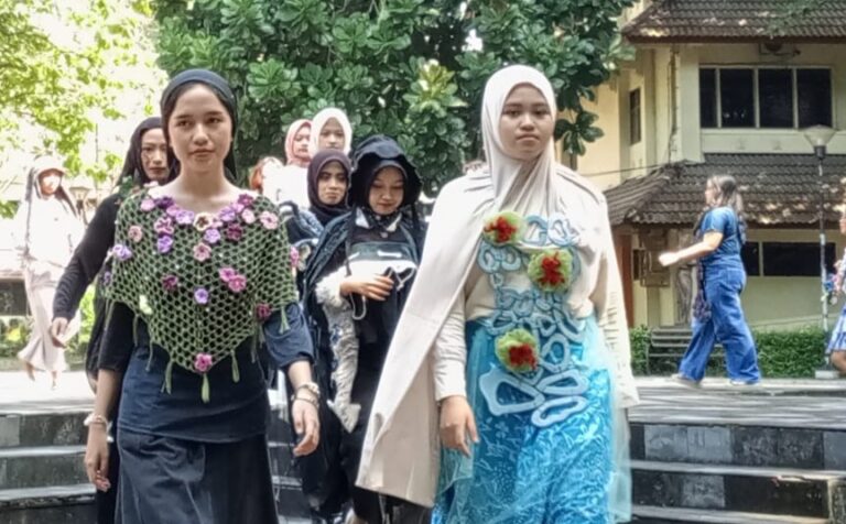 Group of women wearing hijabs and colorful traditional outfits walking down steps outdoors; a building is in view behind them.
